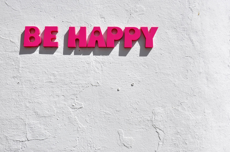 Photo of block lettering of the words 'Be Happy'